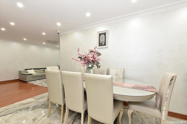 dining room featuring light hardwood / wood-style floors and ornamental molding