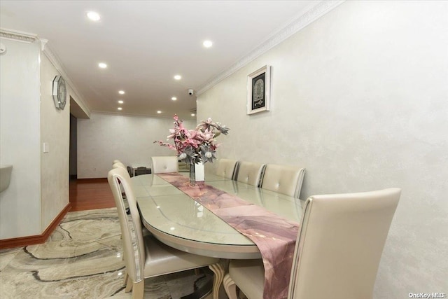 dining room with hardwood / wood-style floors and ornamental molding