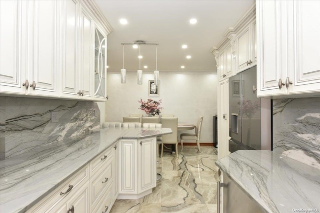 kitchen featuring decorative backsplash, decorative light fixtures, and white cabinets