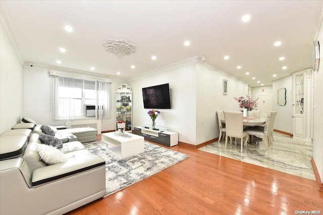 living room featuring ornamental molding and light hardwood / wood-style flooring