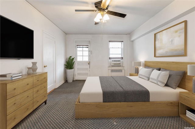 carpeted bedroom featuring ceiling fan, cooling unit, and radiator