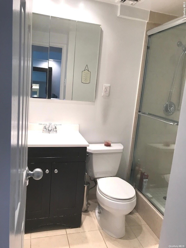 102-10 66th Rd Unit 4G, Forest Hills, NY 11375 - bathroom featuring tile patterned floors, vanity, an enclosed shower, and toilet