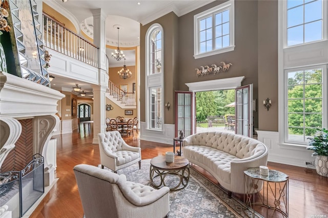 living room featuring a healthy amount of sunlight, a high ceiling, and hardwood / wood-style flooring