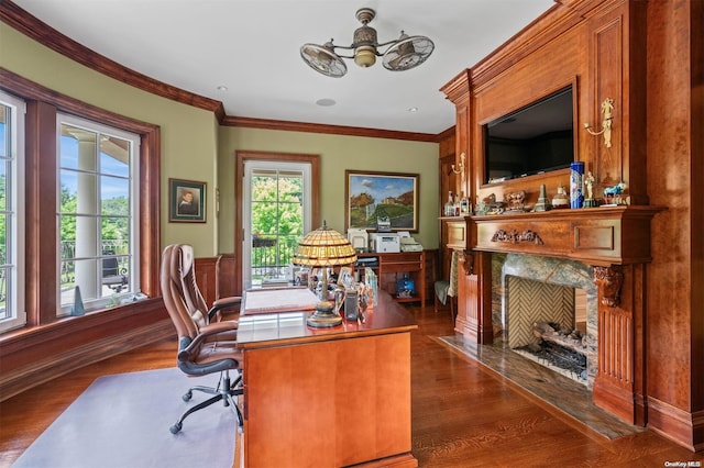 office featuring dark hardwood / wood-style floors, ceiling fan, ornamental molding, and a fireplace