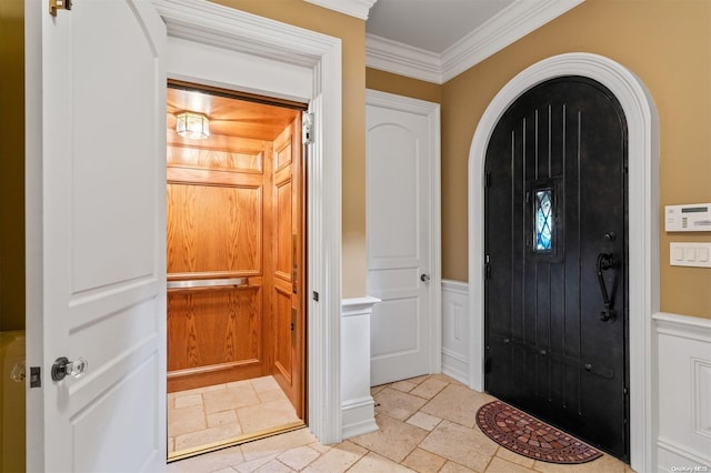 entryway featuring crown molding