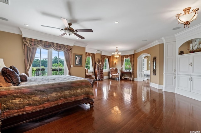 bedroom with dark wood-type flooring, ceiling fan with notable chandelier, and ornamental molding