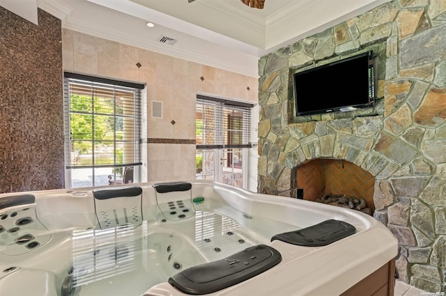 bathroom featuring a bathtub, tile walls, and ornamental molding