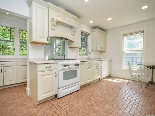 kitchen featuring custom range hood, white electric stove, and sink