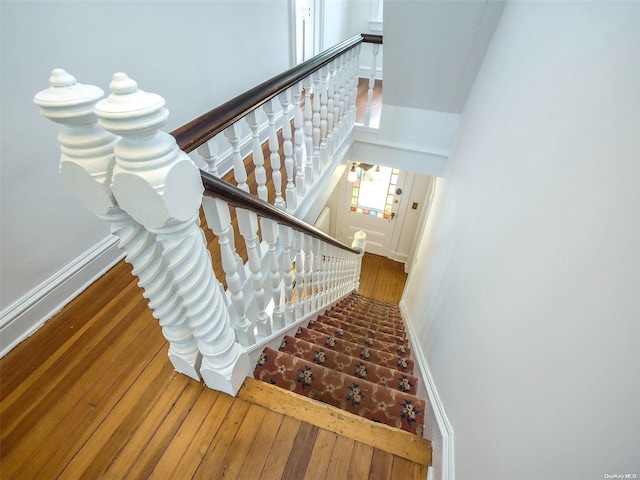 stairway with hardwood / wood-style floors