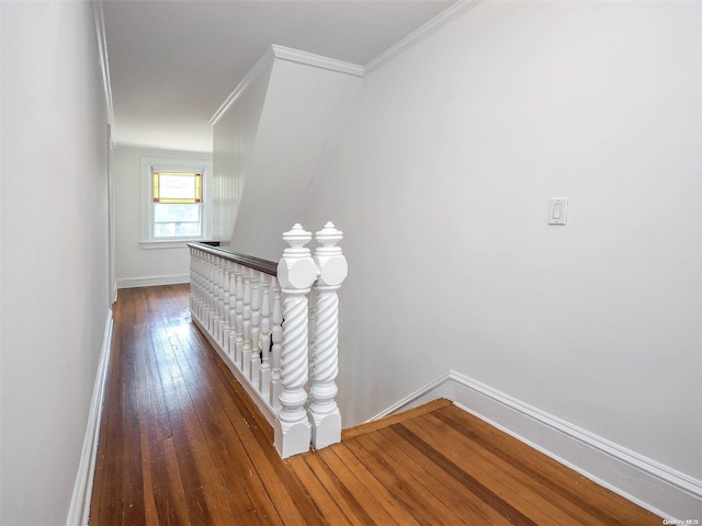 corridor with hardwood / wood-style floors and ornamental molding