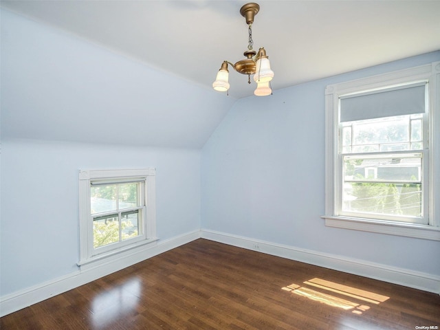 additional living space featuring dark hardwood / wood-style flooring and vaulted ceiling