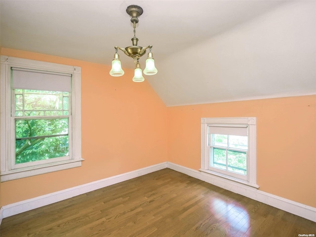 bonus room with a chandelier, dark hardwood / wood-style flooring, and vaulted ceiling