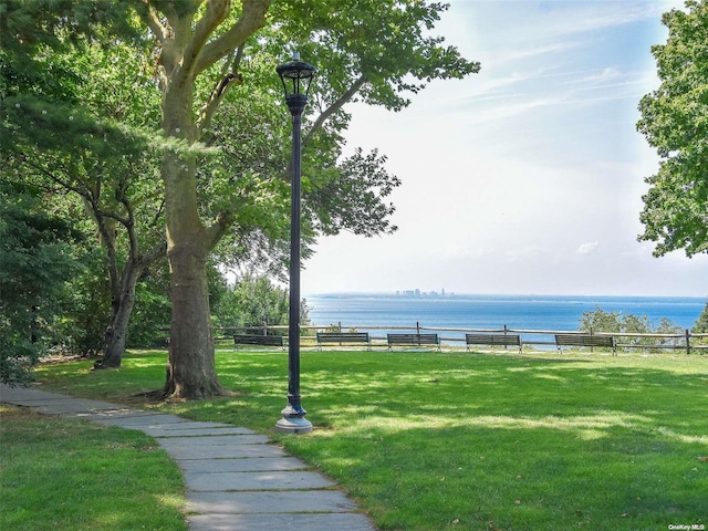 surrounding community featuring a yard and a water view