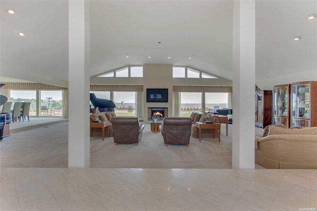 living room featuring light colored carpet, vaulted ceiling, and a wealth of natural light