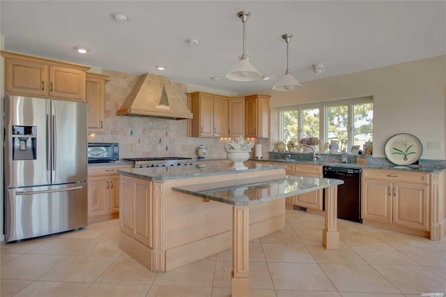 kitchen with black appliances, a kitchen island, light stone counters, and premium range hood