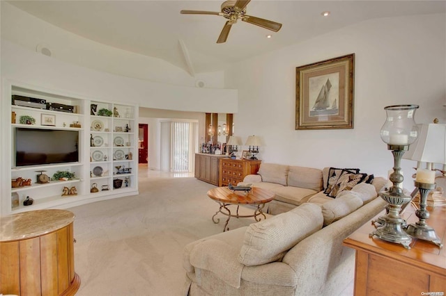 carpeted living room with ceiling fan and lofted ceiling