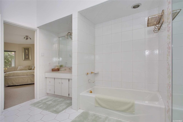 bathroom with tile patterned flooring and tiled shower / bath