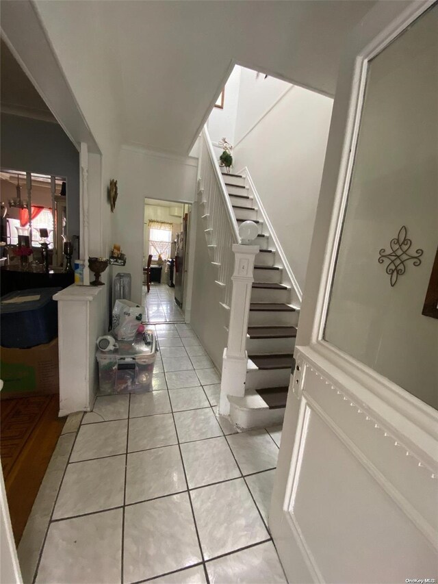 interior space with tile patterned flooring and ornamental molding