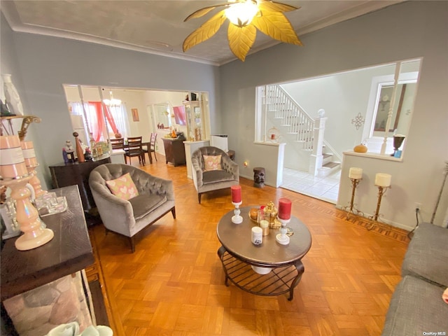 living room featuring ceiling fan, light parquet floors, and ornamental molding