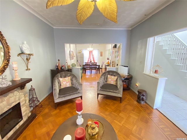 sitting room with a fireplace, parquet flooring, and crown molding