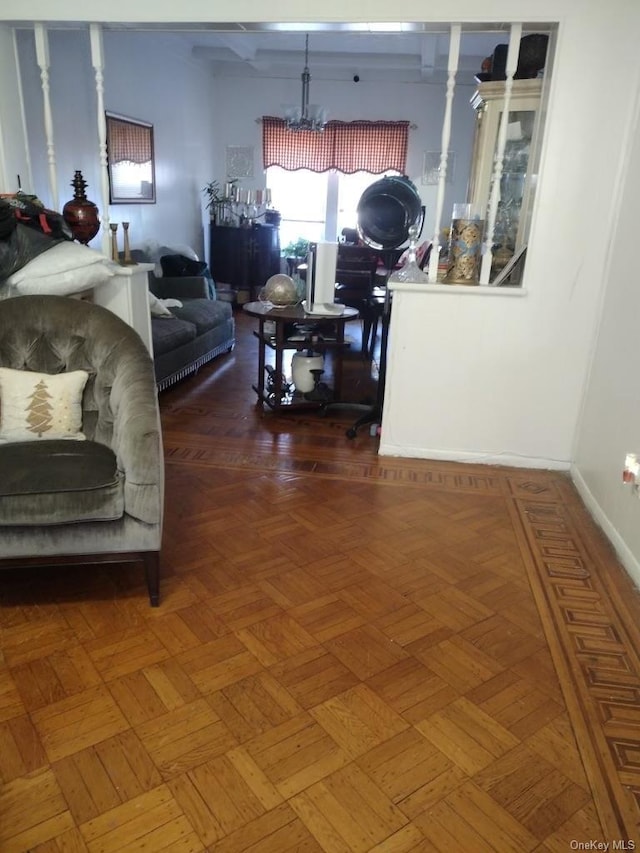 living room with an inviting chandelier and dark parquet floors