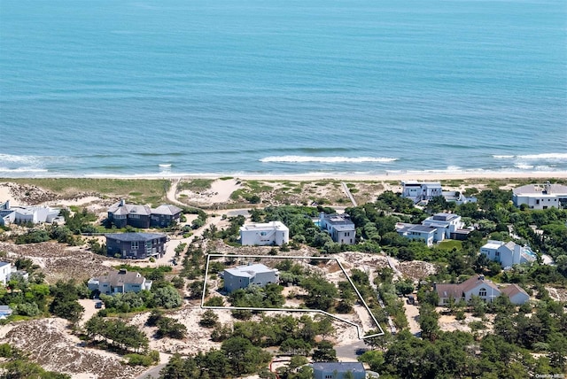 bird's eye view with a water view and a beach view