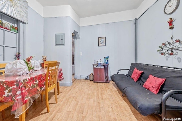 living room featuring electric panel and light hardwood / wood-style floors