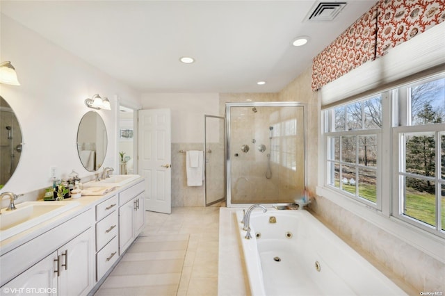 bathroom featuring tile patterned flooring, vanity, and separate shower and tub