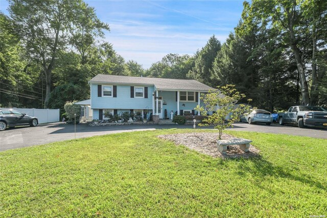 bi-level home with a porch and a front yard