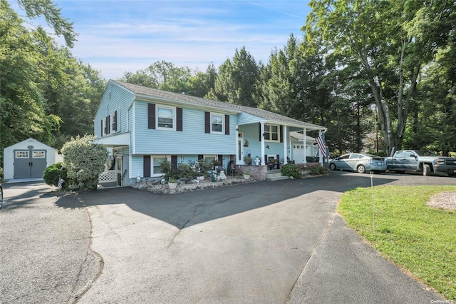 bi-level home with covered porch and a storage unit