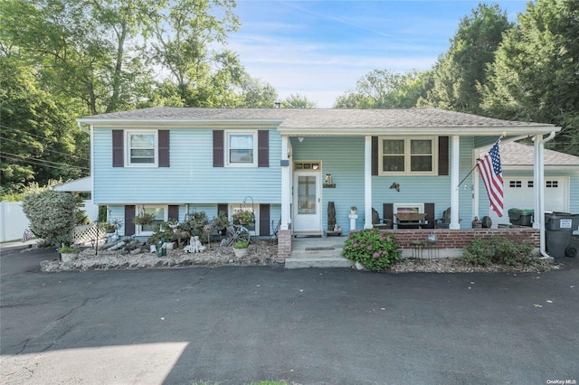 split foyer home with covered porch and a garage