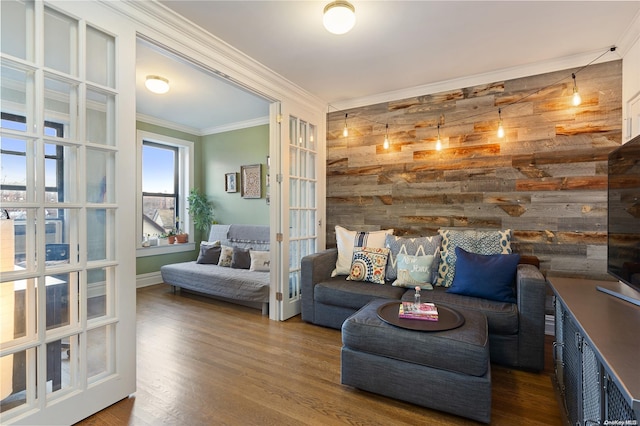 living room with ornamental molding, french doors, dark wood-type flooring, and wood walls