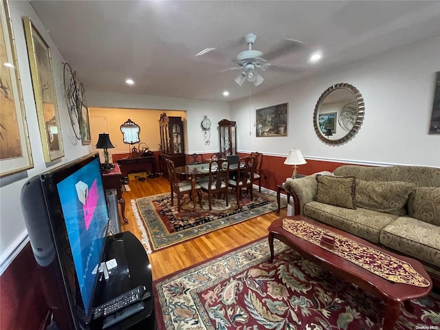 living room featuring hardwood / wood-style flooring and ceiling fan