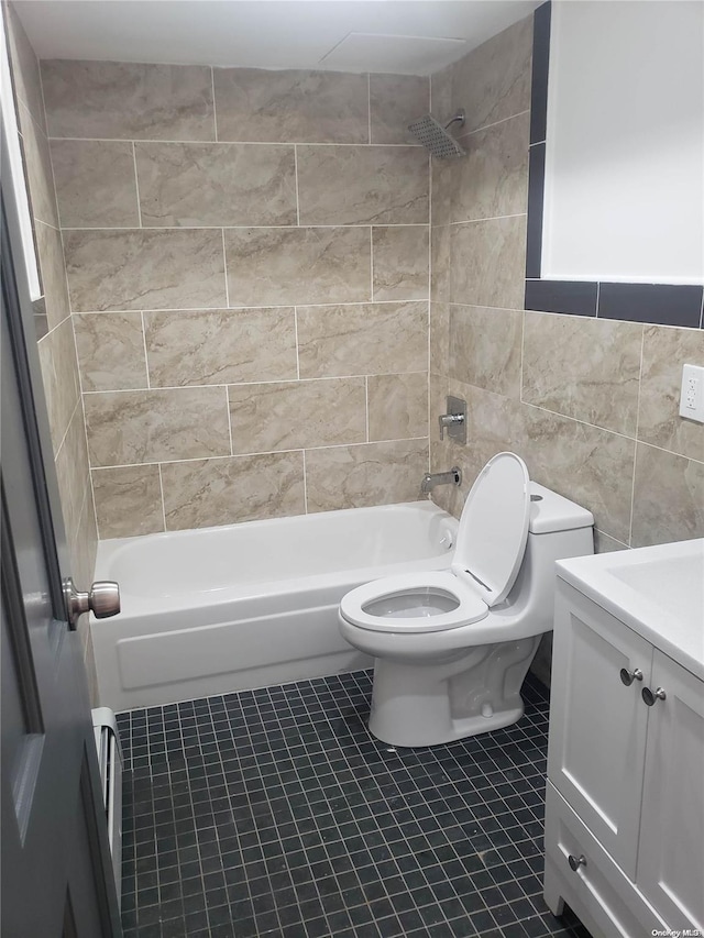 full bathroom featuring tile patterned floors, vanity, tiled shower / bath combo, tile walls, and toilet