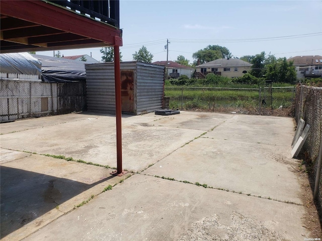 view of patio / terrace featuring a storage unit