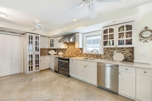 kitchen with white cabinetry, sink, stainless steel appliances, and wall chimney range hood