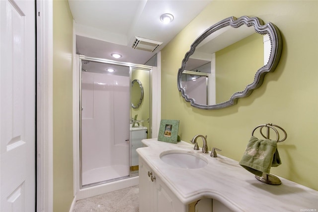 bathroom with vanity and a shower with shower door