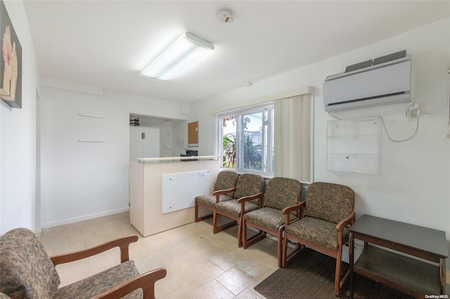 sitting room featuring an AC wall unit