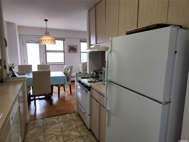 kitchen with pendant lighting, white appliances, dark tile patterned floors, and light brown cabinets