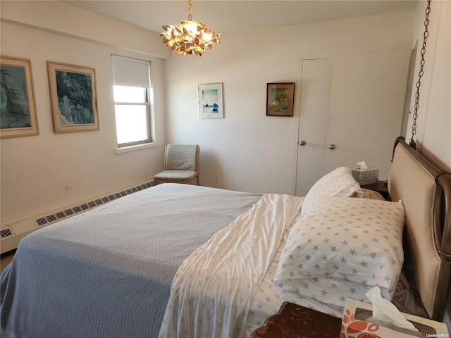 bedroom featuring baseboard heating and a chandelier