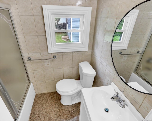 full bathroom featuring tile walls, plenty of natural light, and bath / shower combo with glass door