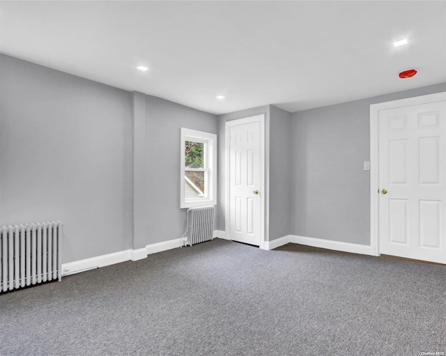 carpeted spare room with radiator