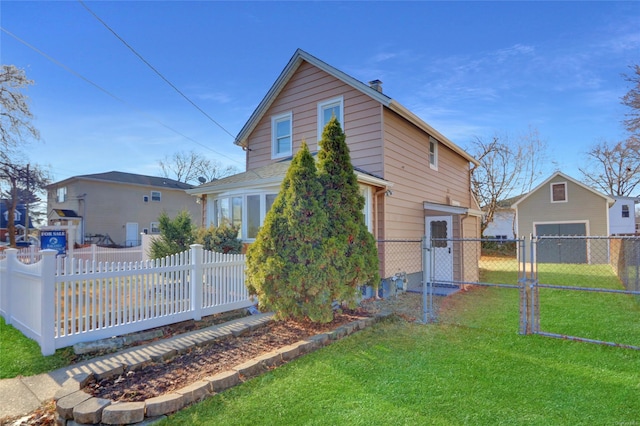 back of house featuring an outbuilding, a yard, and a garage