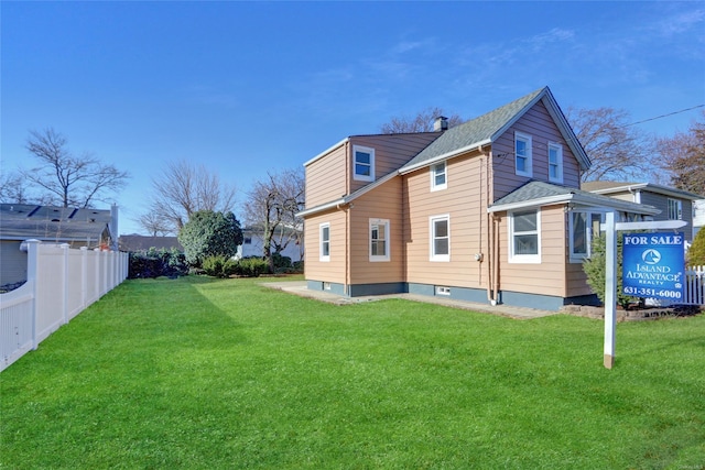 rear view of property featuring a lawn