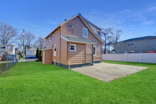 rear view of house with a yard and a patio