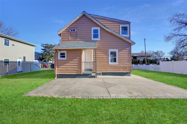 back of property featuring a patio area and a yard