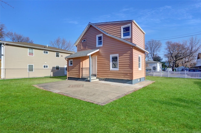 rear view of property with a yard and a patio