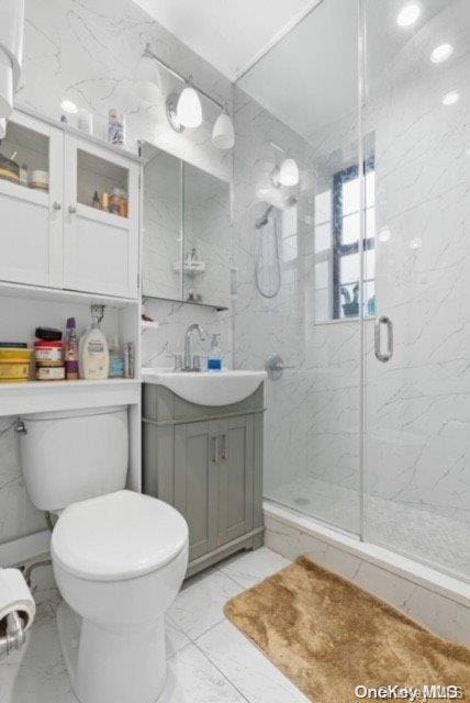 bathroom with vanity, toilet, and walk in shower