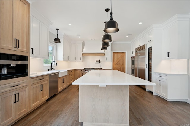 kitchen featuring a center island, sink, stainless steel appliances, premium range hood, and light brown cabinetry