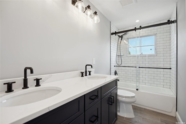 full bathroom featuring shower / bath combination with glass door, vanity, and toilet